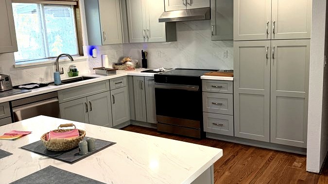 Custom kitchen renovation with grey shaker cabinets and quartz countertops